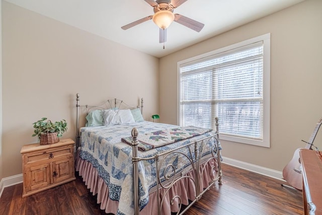 bedroom with baseboards, dark wood finished floors, and multiple windows