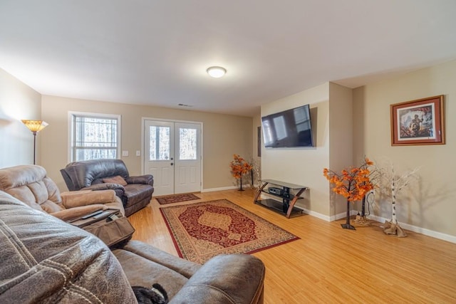 living room featuring light wood-type flooring and baseboards