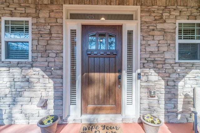 doorway to property with stone siding