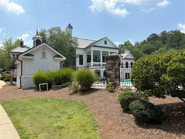 30 Riverrock Trl, Dallas, GA 30157 - rear view of property featuring board and batten siding, a chimney, and a metal roof