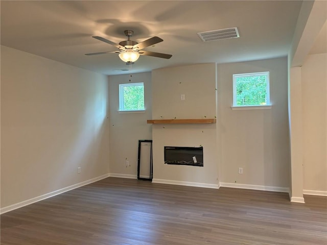 30 Riverrock Trl, Dallas, GA 30157 - unfurnished living room featuring dark wood-style flooring, a ceiling fan, and a glass covered fireplace