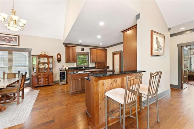274 Ramey Rd, Westminster, SC 29693 - kitchen featuring beverage cooler, wood-type flooring, brown cabinets, a peninsula, and a chandelier