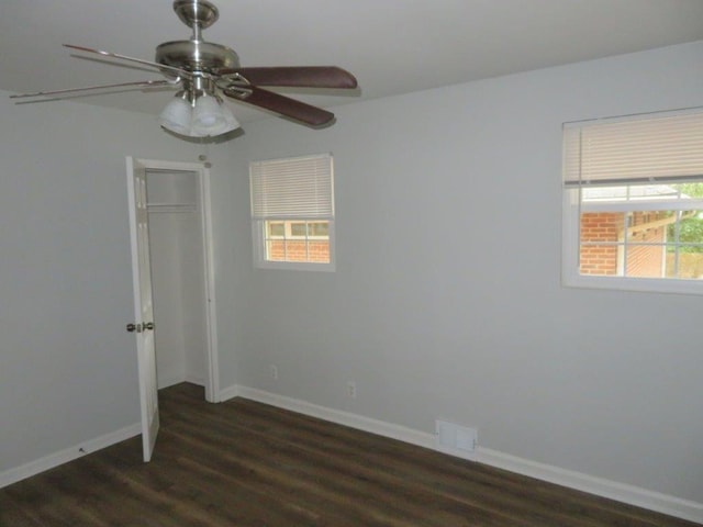 empty room featuring ceiling fan and dark hardwood / wood-style flooring