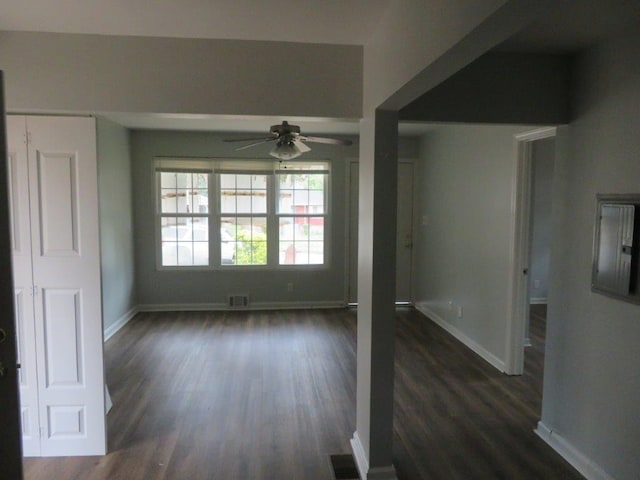 interior space featuring dark wood-type flooring and ceiling fan