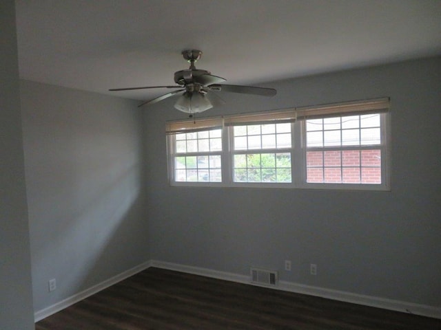 unfurnished room with ceiling fan, plenty of natural light, and dark hardwood / wood-style flooring