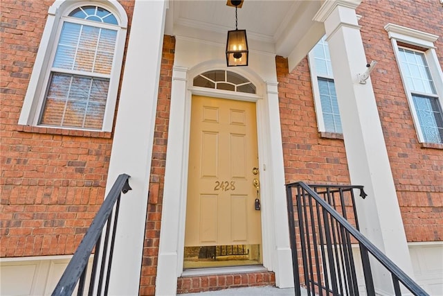 property entrance featuring brick siding