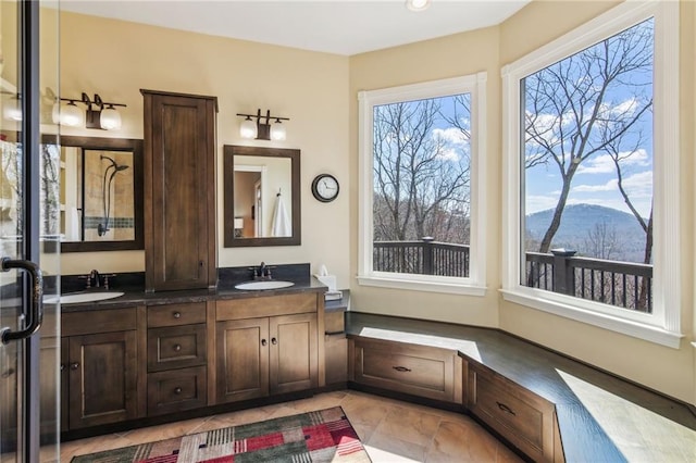 bathroom with a sink, a mountain view, and double vanity