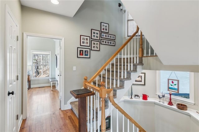 stairs featuring baseboards and wood finished floors