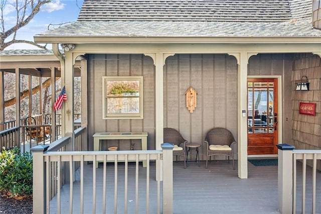 entrance to property featuring a shingled roof