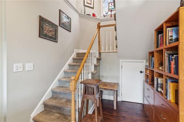 stairs featuring baseboards and wood finished floors