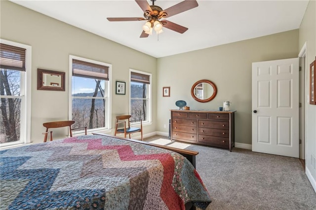 carpeted bedroom with a ceiling fan and baseboards