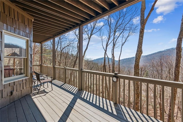 wooden deck featuring a forest view