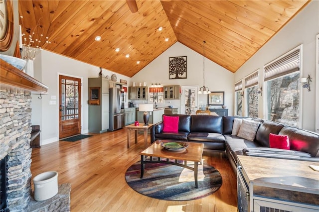 living room with wooden ceiling, a fireplace, and a healthy amount of sunlight