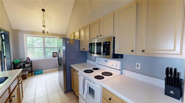 kitchen featuring decorative light fixtures, vaulted ceiling, light countertops, stainless steel microwave, and white range with electric stovetop