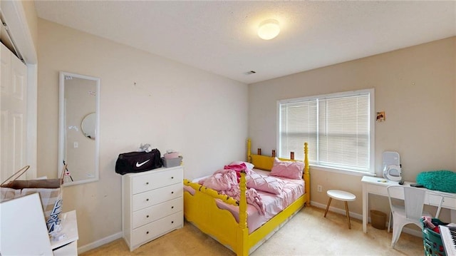 bedroom featuring visible vents and light colored carpet
