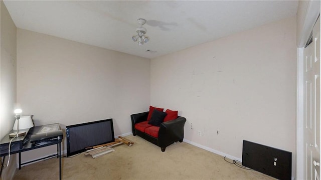 sitting room featuring carpet floors and baseboards