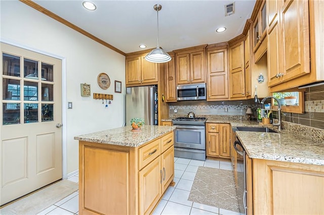 kitchen featuring appliances with stainless steel finishes, sink, hanging light fixtures, a center island, and light stone counters