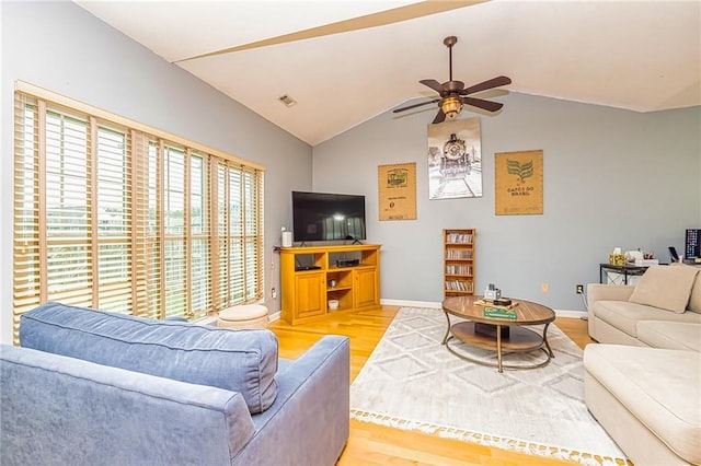 living room featuring ceiling fan, vaulted ceiling, and hardwood / wood-style floors