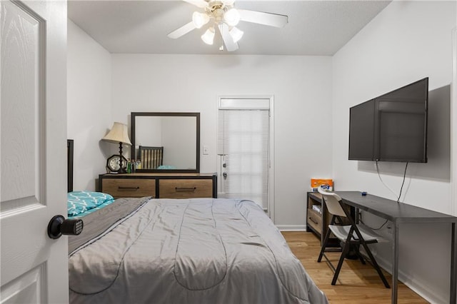 bedroom with light hardwood / wood-style floors and ceiling fan