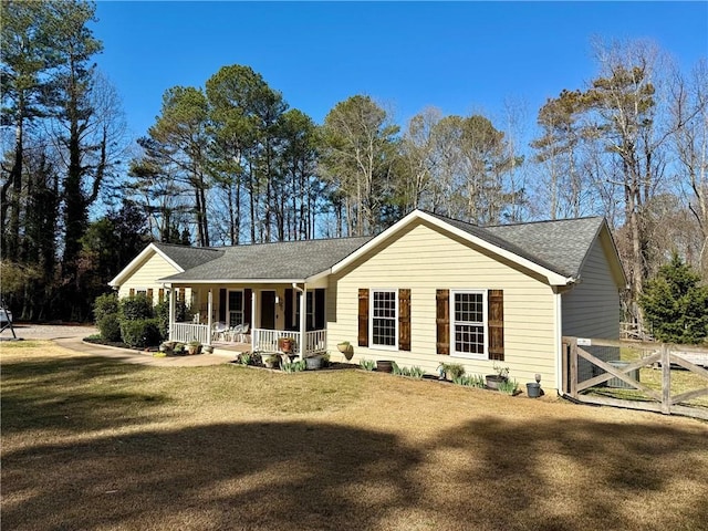 ranch-style house with a porch and a front yard