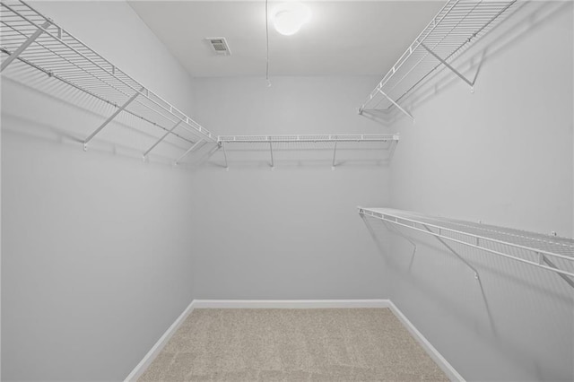 spacious closet with visible vents and carpet floors