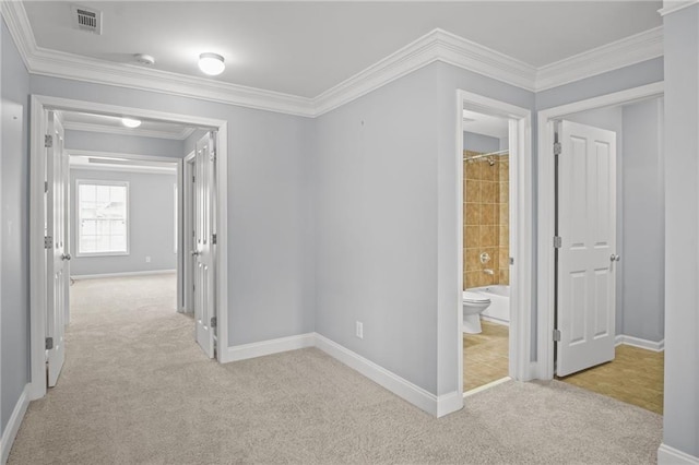 hall featuring carpet flooring, baseboards, crown molding, and visible vents