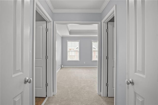 hall with crown molding, carpet, and baseboards