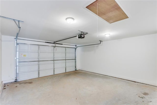 garage with baseboards and a garage door opener