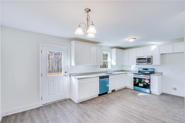 kitchen with stainless steel appliances, light wood-type flooring, white cabinetry, and a sink