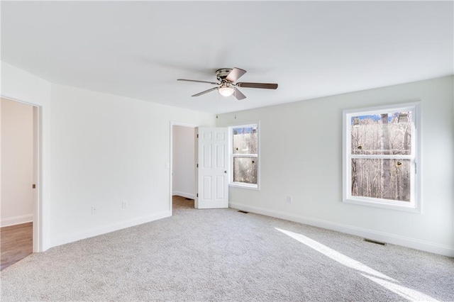 unfurnished bedroom featuring carpet, visible vents, and baseboards