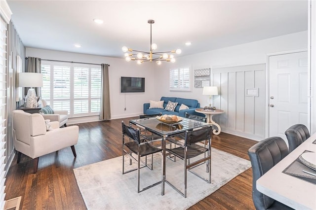 dining room with dark wood-type flooring, baseboards, recessed lighting, and a chandelier