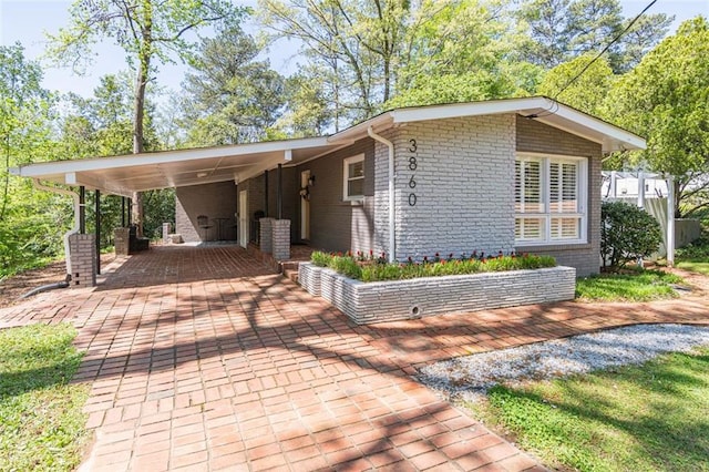 view of property exterior with a carport and brick siding