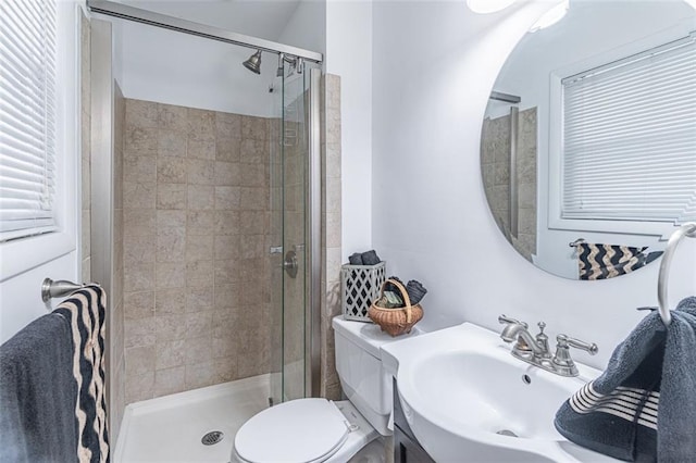 full bath featuring toilet, vanity, and a stall shower