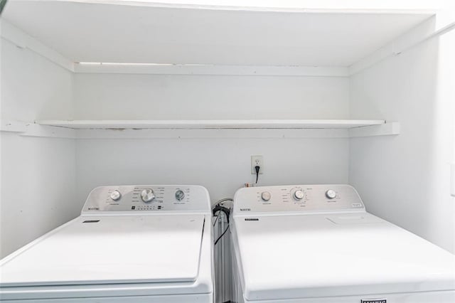 laundry area featuring separate washer and dryer and laundry area