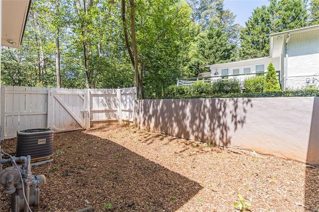 view of yard with central AC unit and fence