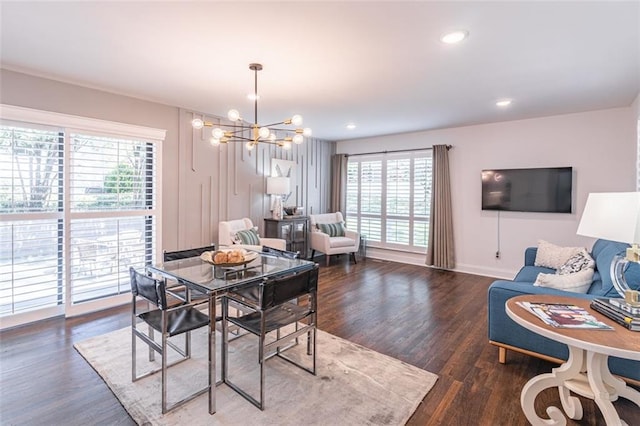 dining room with plenty of natural light, a notable chandelier, and wood finished floors