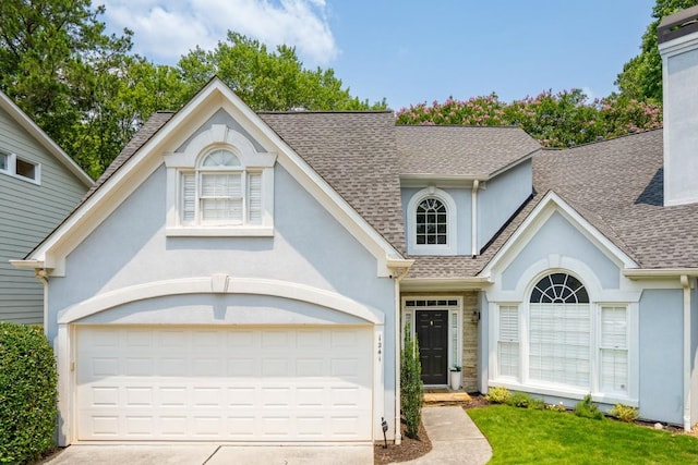 1241 Newbridge Trce, Brookhaven, GA 30319 - view of front of home featuring roof with shingles, driveway, stucco siding, and a garage