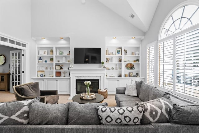 1241 Newbridge Trce, Brookhaven, GA 30319 - living room with high vaulted ceiling, healthy amount of natural light, a premium fireplace, and built in shelves