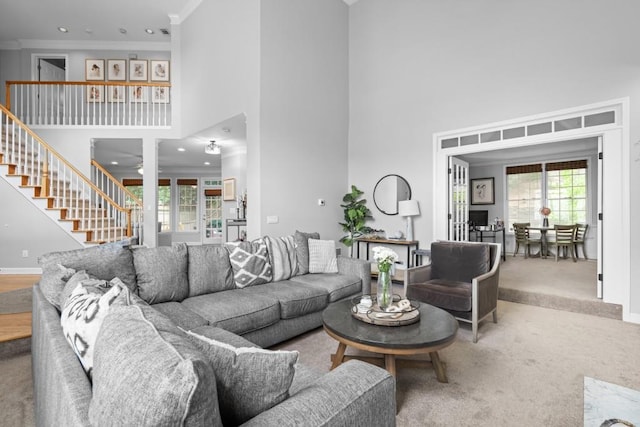 1241 Newbridge Trce, Brookhaven, GA 30319 - carpeted living room with a towering ceiling, stairs, crown molding, and recessed lighting