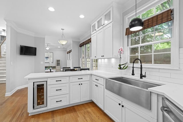 1241 Newbridge Trce, Brookhaven, GA 30319 - kitchen featuring beverage cooler, a peninsula, tasteful backsplash, light countertops, and dishwasher