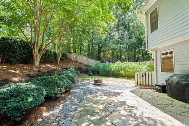 1241 Newbridge Trce, Brookhaven, GA 30319 - fenced backyard with area for grilling, a fire pit, and a patio