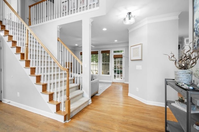 1241 Newbridge Trce, Brookhaven, GA 30319 - stairway featuring crown molding, decorative columns, wood finished floors, and recessed lighting
