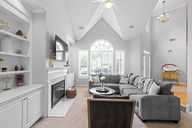1241 Newbridge Trce, Brookhaven, GA 30319 - living room featuring a fireplace, light colored carpet, ceiling fan, and a chandelier