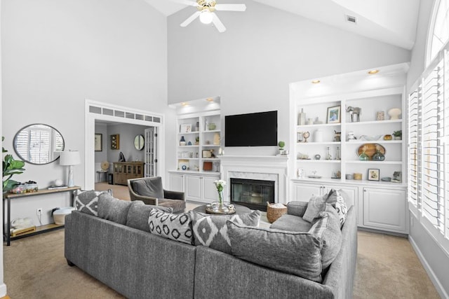 1241 Newbridge Trce, Brookhaven, GA 30319 - living room featuring light carpet, high vaulted ceiling, healthy amount of natural light, ceiling fan, and a premium fireplace