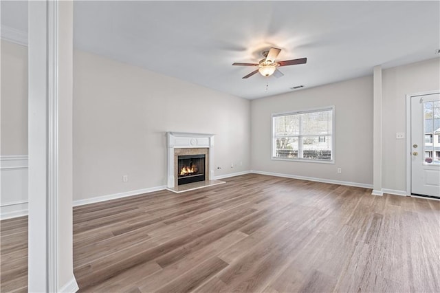 1558 Autumn Wood Trl, Sugar Hill, GA 30518 - unfurnished living room featuring visible vents, baseboards, wood finished floors, ceiling fan, and a fireplace