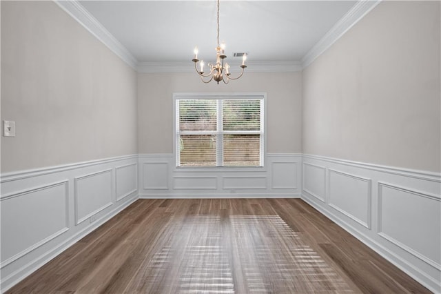 1558 Autumn Wood Trl, Sugar Hill, GA 30518 - unfurnished dining area featuring a wainscoted wall, wood finished floors, a chandelier, and crown molding