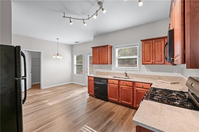 1558 Autumn Wood Trl, Sugar Hill, GA 30518 - kitchen featuring light wood-style flooring, a sink, an inviting chandelier, light countertops, and black appliances