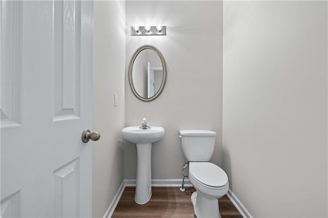 1558 Autumn Wood Trl, Sugar Hill, GA 30518 - half bathroom with wood finished floors, toilet, and baseboards