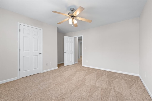1558 Autumn Wood Trl, Sugar Hill, GA 30518 - unfurnished bedroom with carpet flooring, baseboards, and a ceiling fan