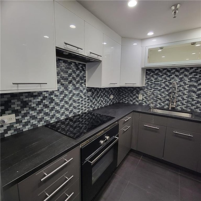 375 Ralph Mcgill Blvd Unit 505, Atlanta, GA 30312 - kitchen with a sink, under cabinet range hood, black appliances, dark countertops, and white cabinets
